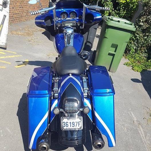 A blue motorcycle with a license plate that says 36197f