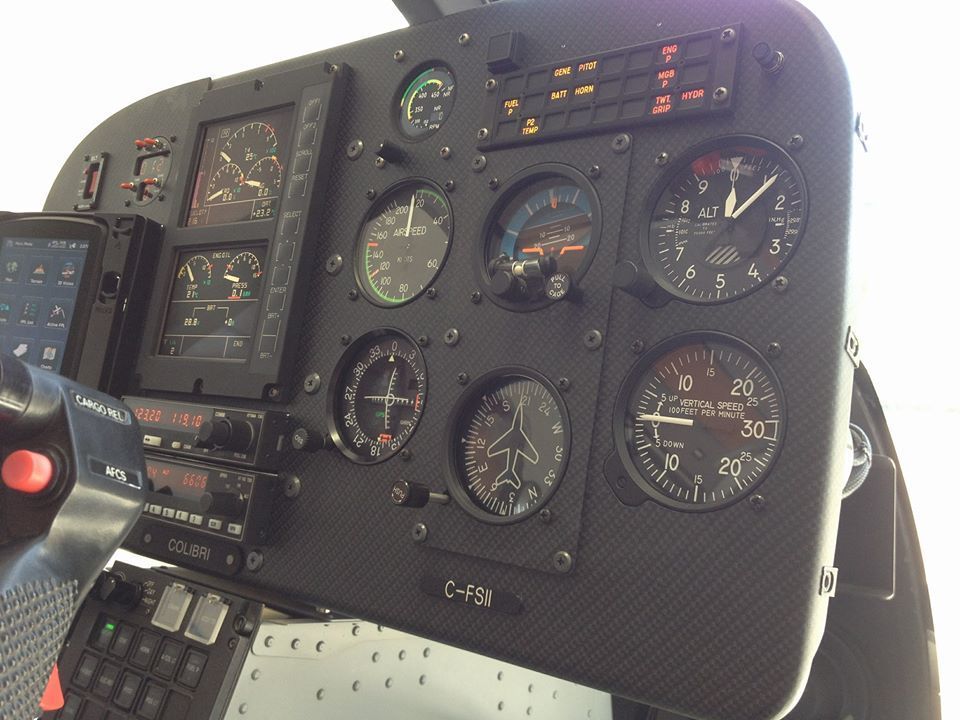 A cockpit of an airplane with a clock on it