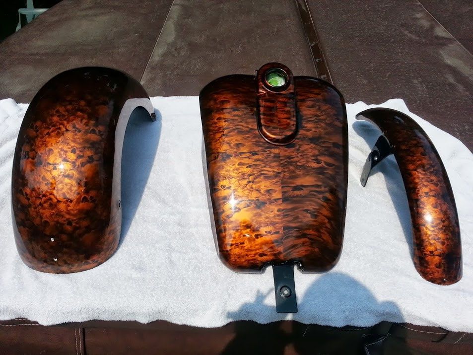 A set of fenders and a tank on a white towel