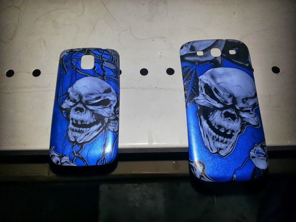 Two blue cell phone cases with skulls on them
