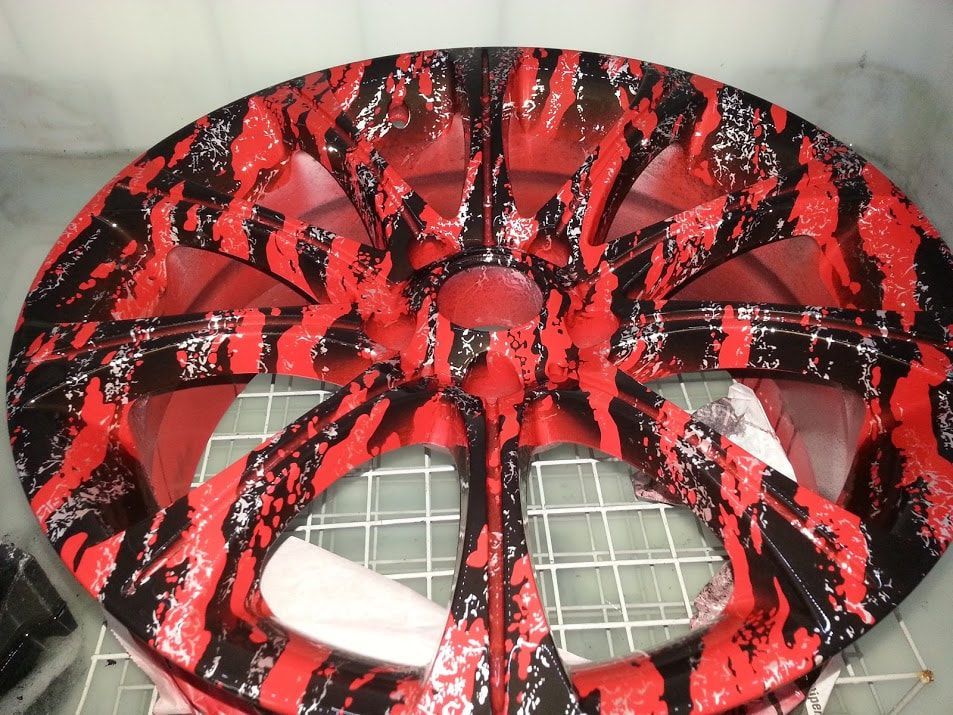 A red and black wheel is sitting on a table