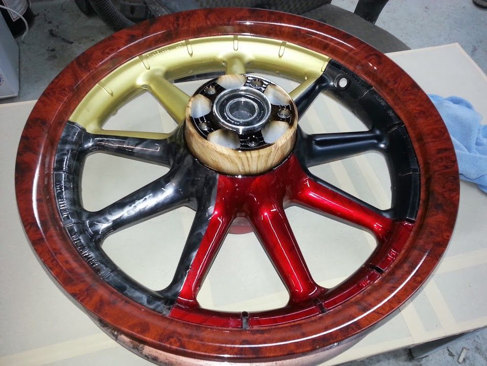 A wheel with a wooden rim is sitting on a table