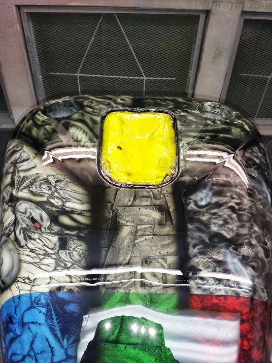 A close up of a colorful helmet with a yellow emblem on it.