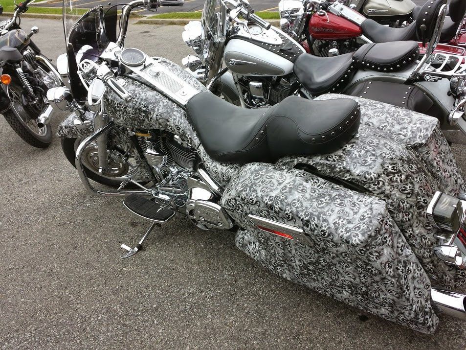 A group of motorcycles are parked in a parking lot