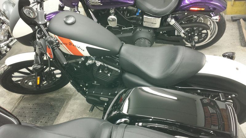 A row of harley davidson motorcycles are parked in a garage