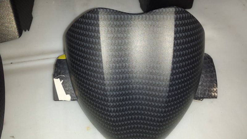 A black item with a pattern on it is sitting on a table