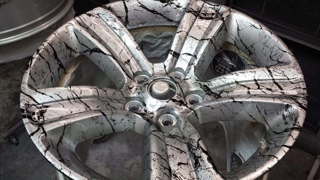 A close up of a wheel with a black and white design on it.