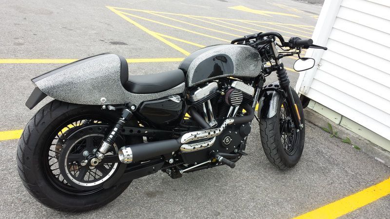 A harley davidson motorcycle is parked in a parking lot