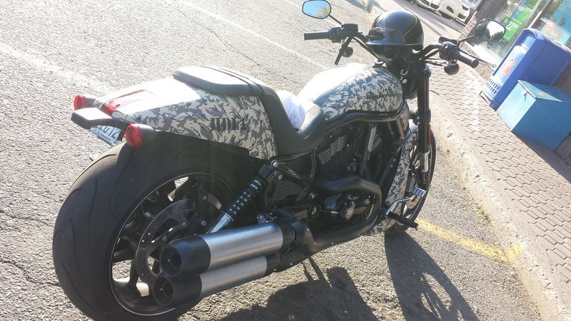 A motorcycle is parked on the side of the road.