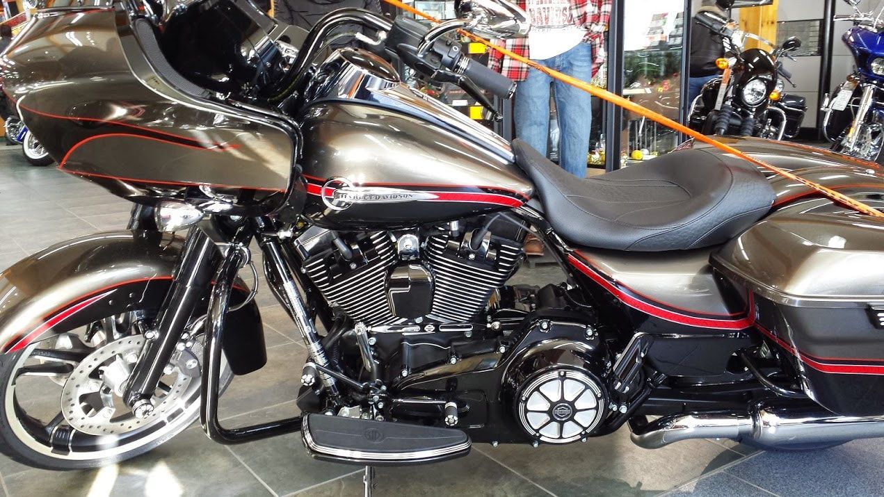 A harley davidson motorcycle is parked in a showroom.