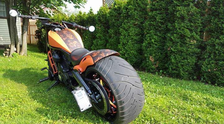 A motorcycle is parked in the grass in a yard.