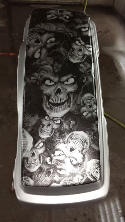 A black and white photo of a car with skulls on it.