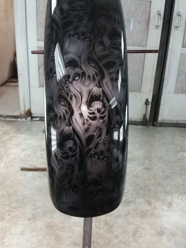 A motorcycle fender with a skull design on it