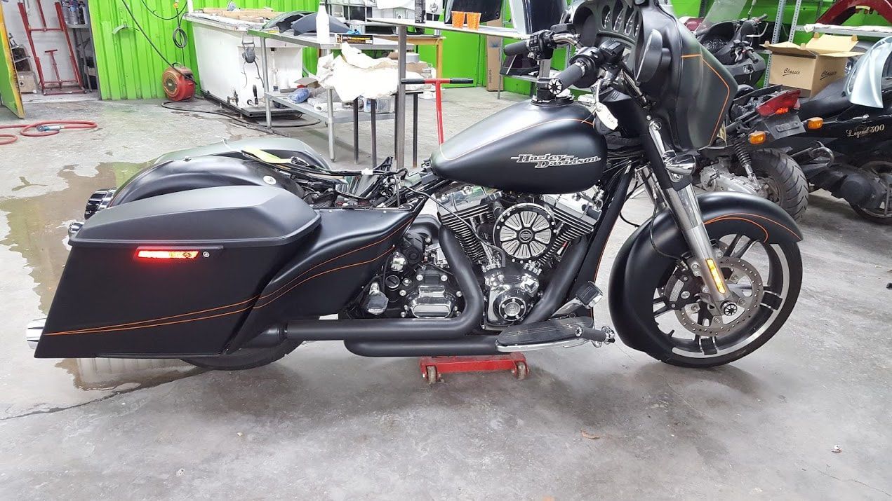 A black harley davidson motorcycle is parked in a garage.