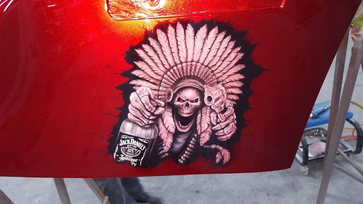 A painting of a skull wearing a native american headdress