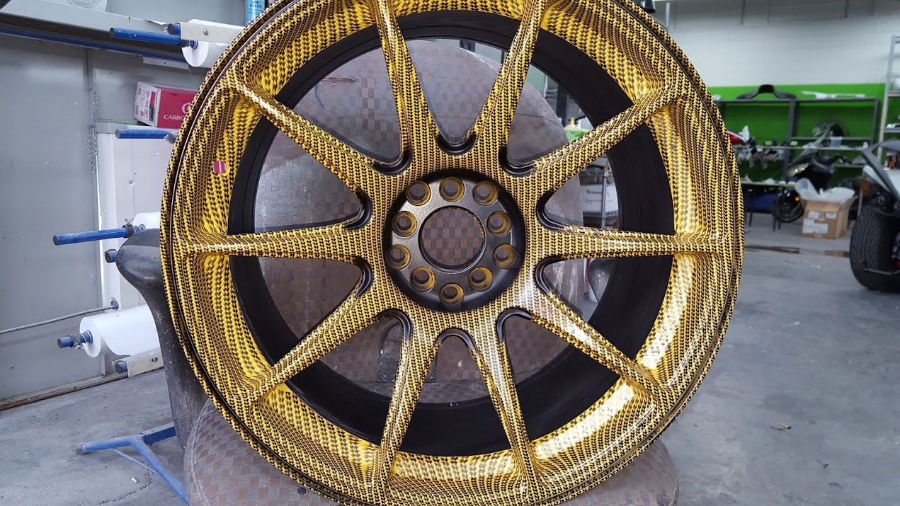 A black and gold wheel is sitting on a table.
