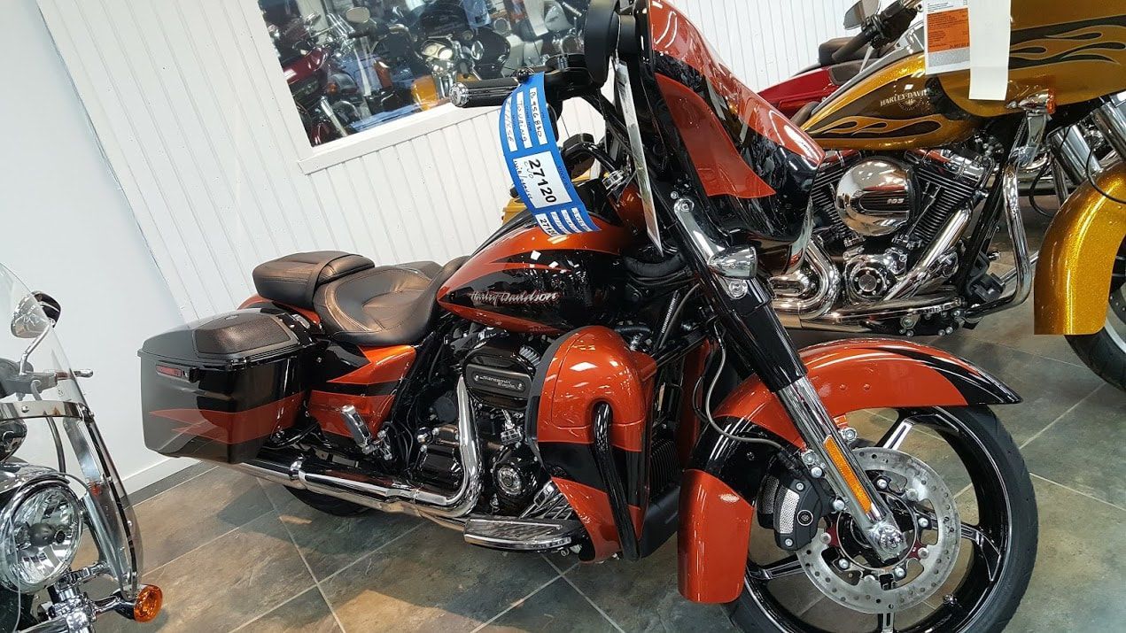 A harley davidson motorcycle is parked in a showroom.