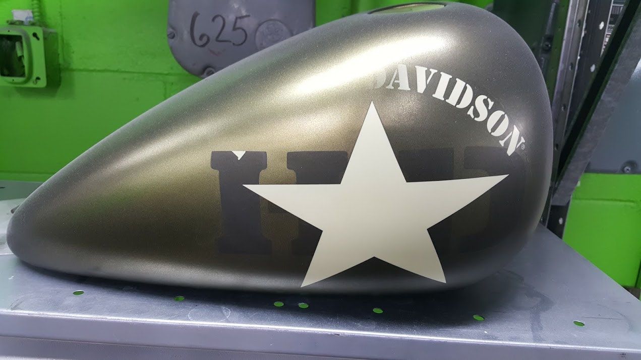 A harley davidson motorcycle tank with a star on it