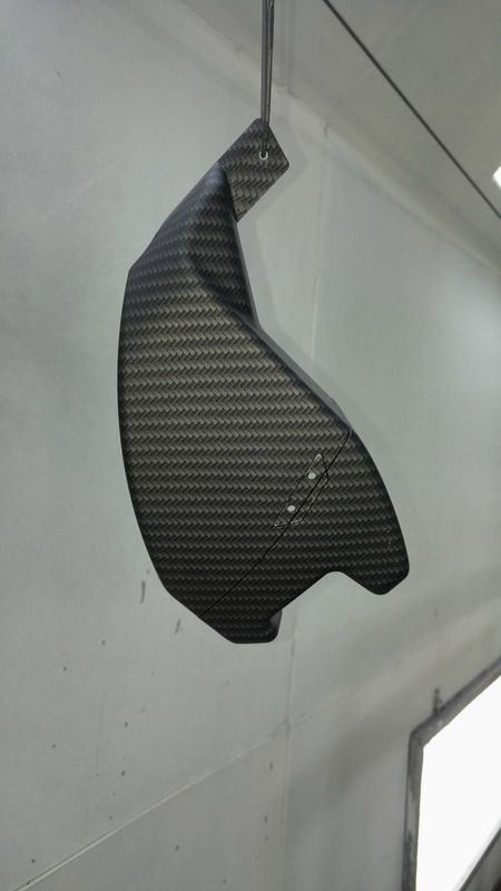 A piece of carbon fiber is hanging from the ceiling.