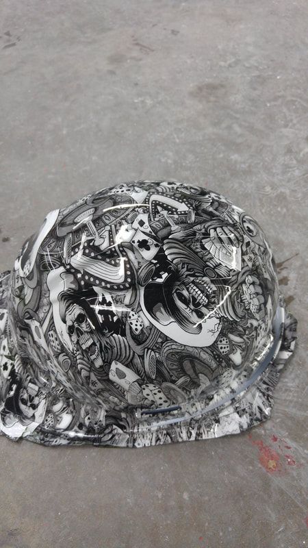 A black and white photo of a helmet with a skull on it.