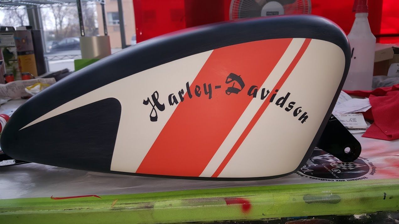 A harley davidson motorcycle tank sits on a table