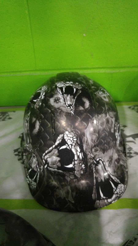 A helmet with a skull design on it is sitting on a table.