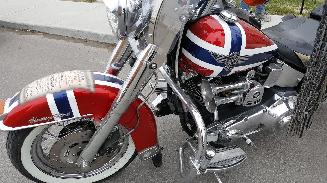 A red white and blue motorcycle is parked on the street