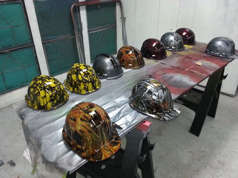 A bunch of hard hats are sitting on a table