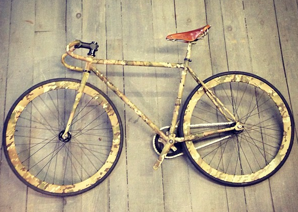 A bicycle is sitting on a wooden floor
