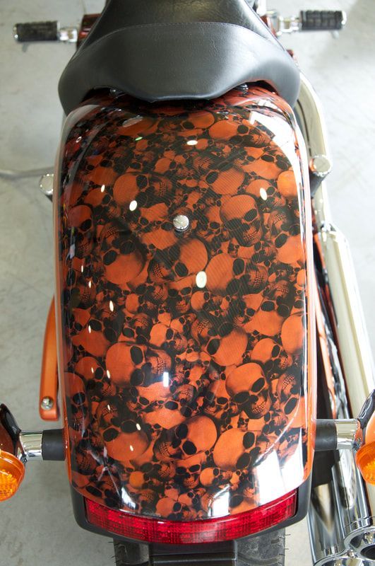 The back of a motorcycle with skulls painted on it