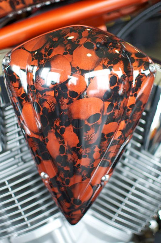 A diamond shaped object with skulls painted on it