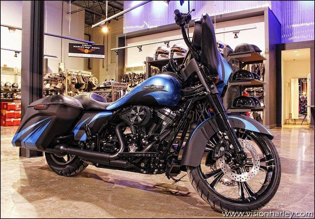 A blue and black harley davidson motorcycle is parked in a store