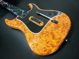 A close up of a guitar on a black surface.