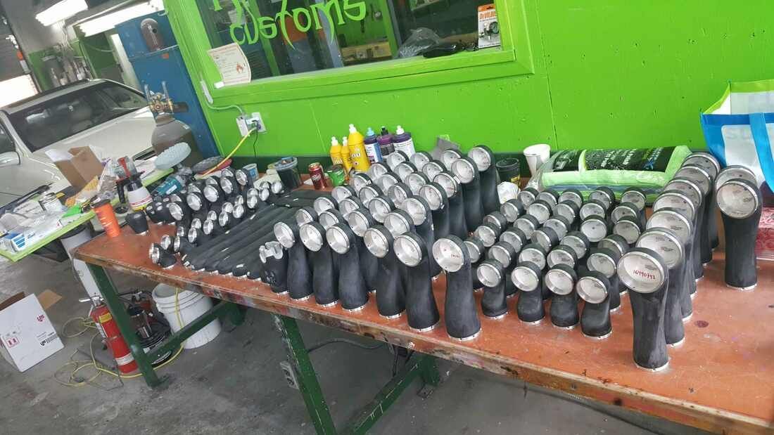 A table with a lot of bottles on it in a garage.