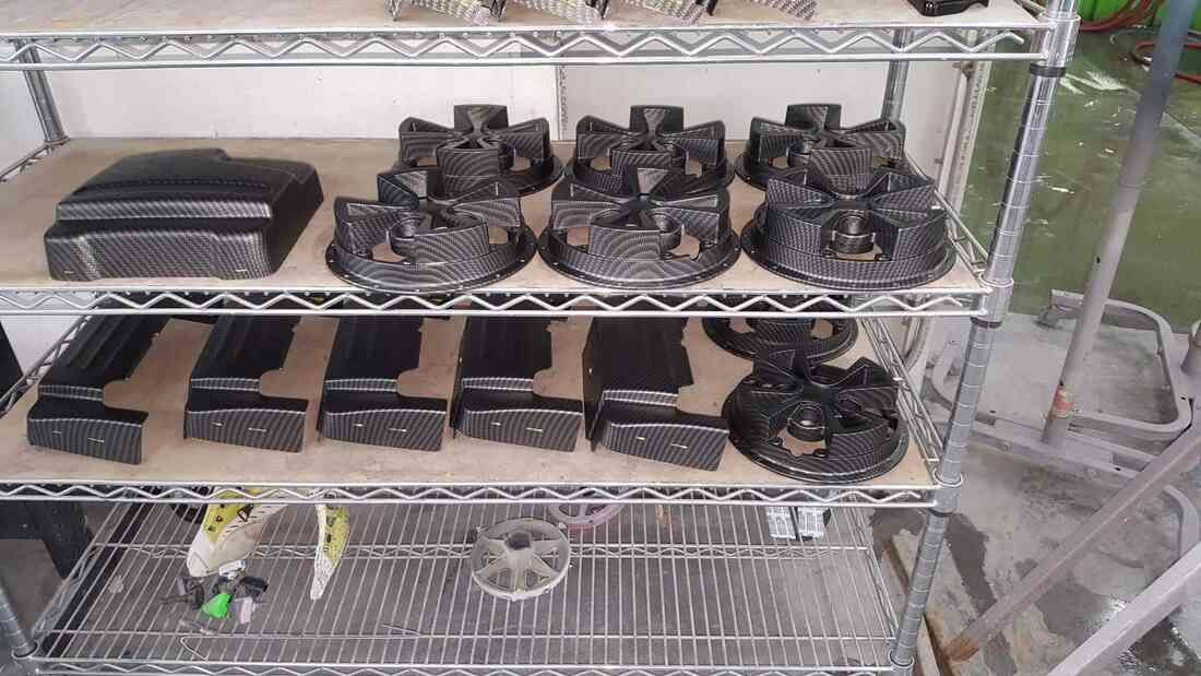 A metal rack filled with lots of black objects.