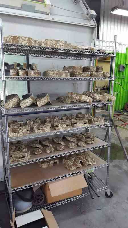 A metal rack filled with lots of rocks in a room.