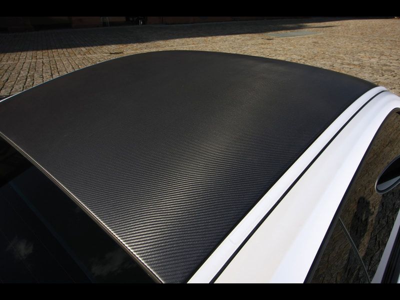A black and white car with a carbon fiber roof