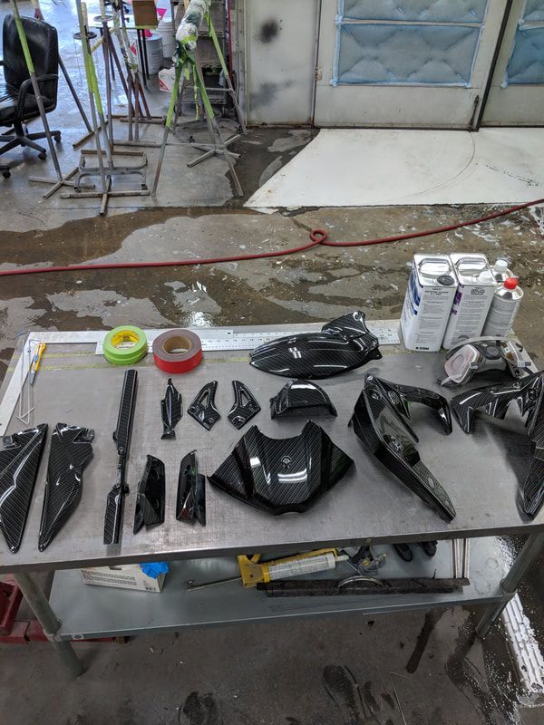 A table with a bunch of motorcycle parts on it