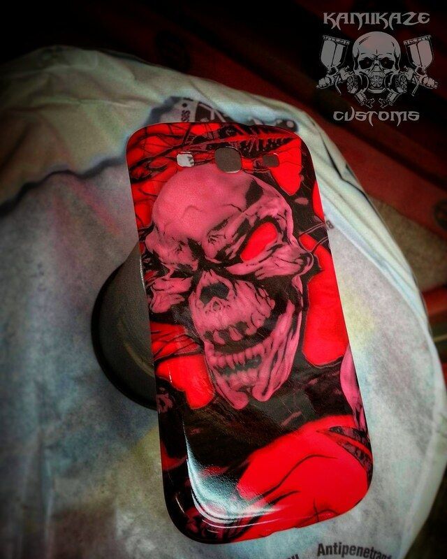 A phone case with a red skull on it