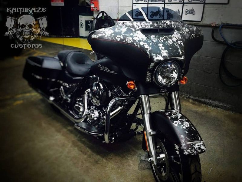 A black harley davidson motorcycle is parked in a garage