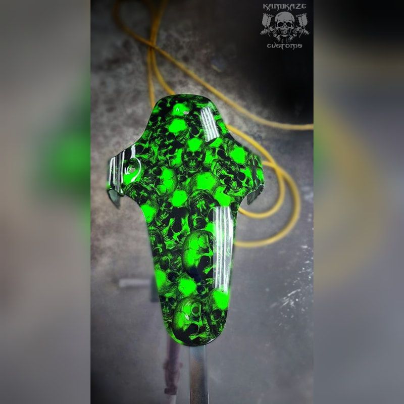 A green and black item with skulls on it is sitting on a table.