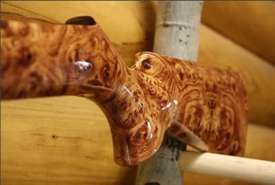 A close up of a wooden sculpture on a wooden wall.