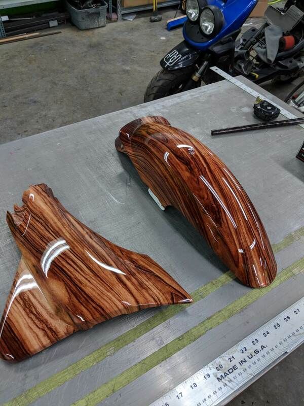 Two pieces of wood are sitting on a table next to a ruler.