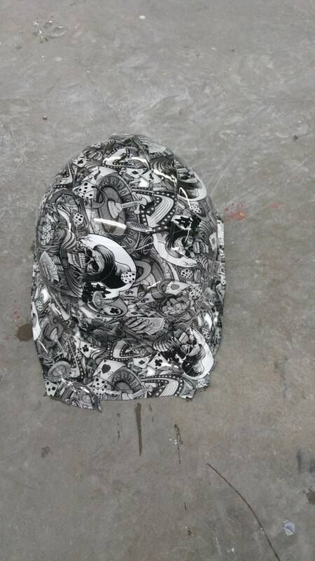 A black and white object is sitting on a concrete surface.