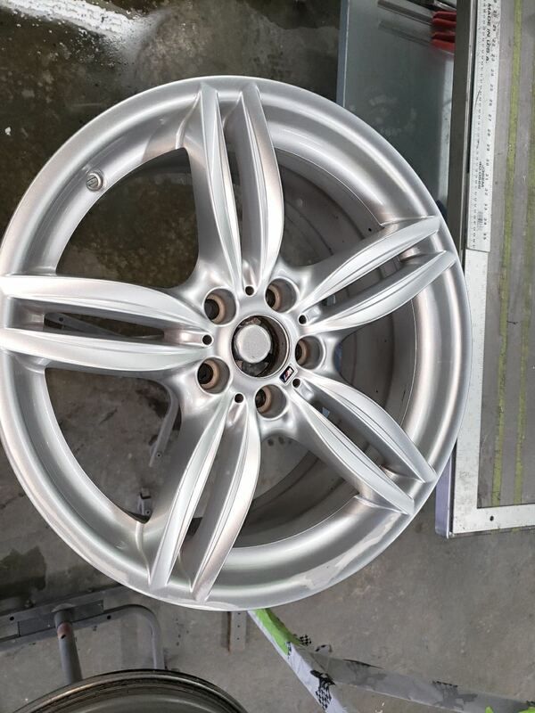 A close up of a silver car wheel on a table