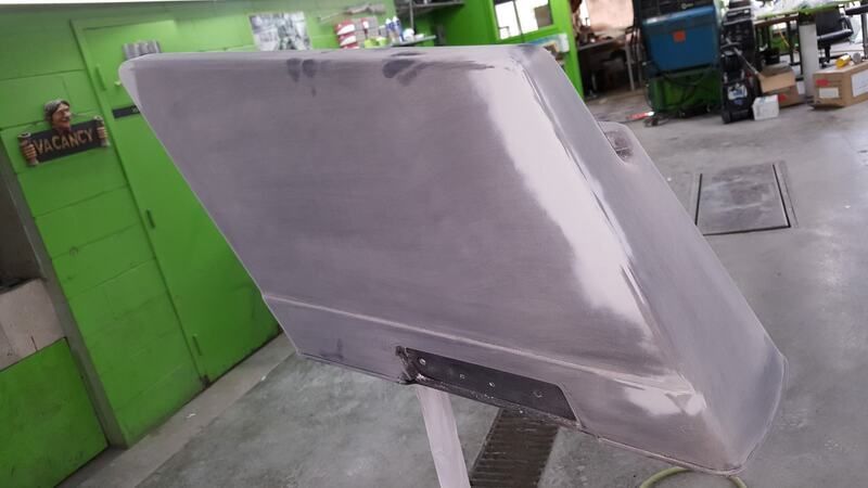 A piece of plastic is sitting on a table in a garage.