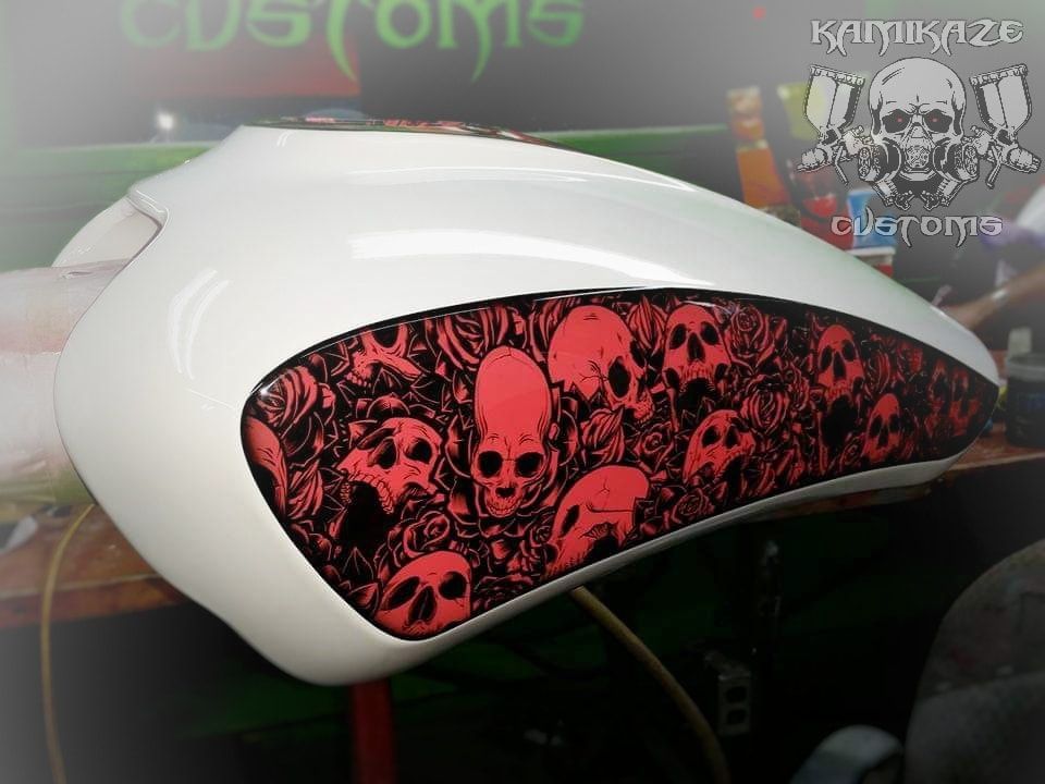 A white tank with red and black skulls on it