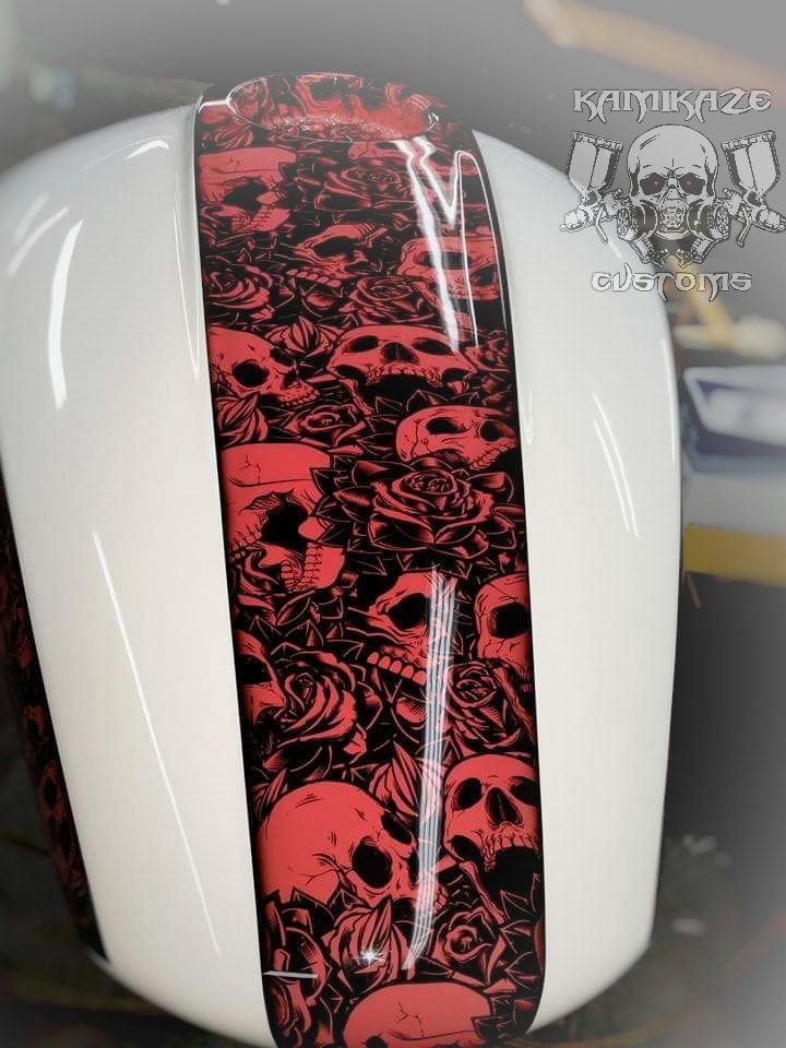 A white helmet with red and black skulls on it
