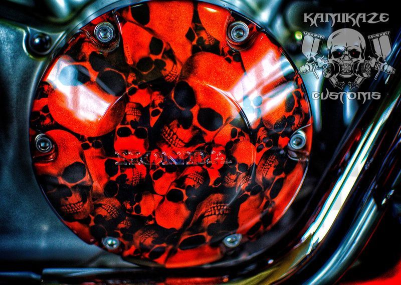 A close up of a motorcycle with skulls painted on it