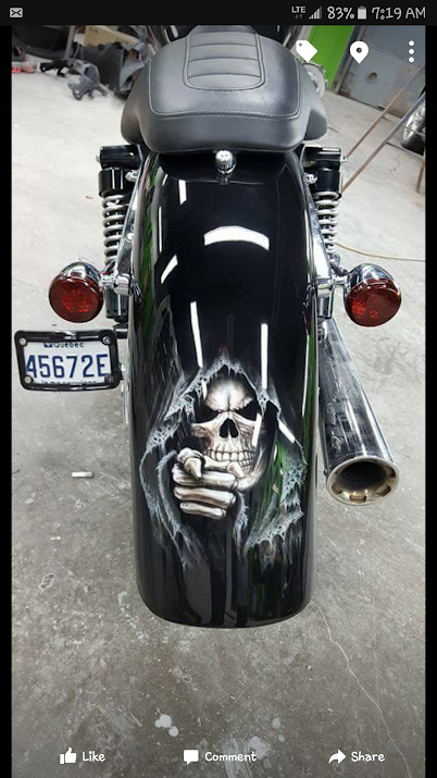 A motorcycle with a grim reaper painted on it